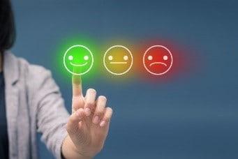 Women pressing smiley face emoticon